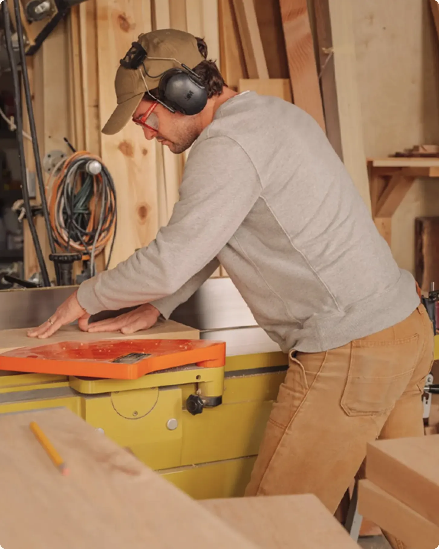 Contractor working at a table saw in a wood workshop